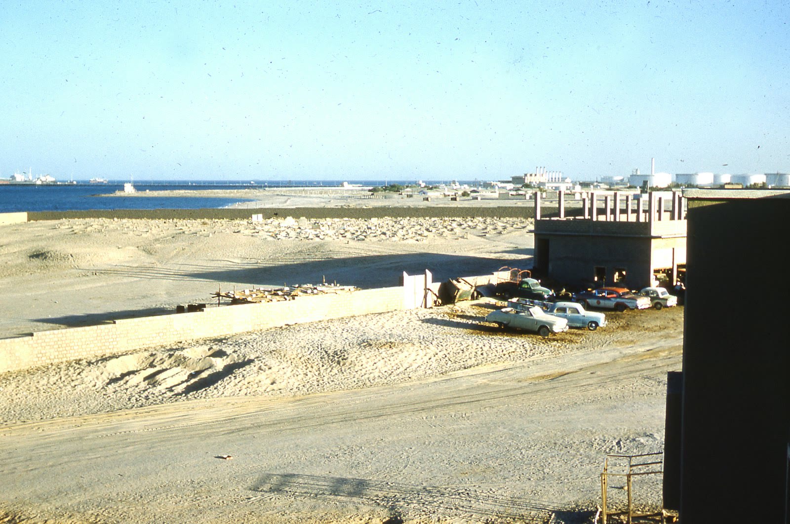 white and black wooden house on beach during daytime