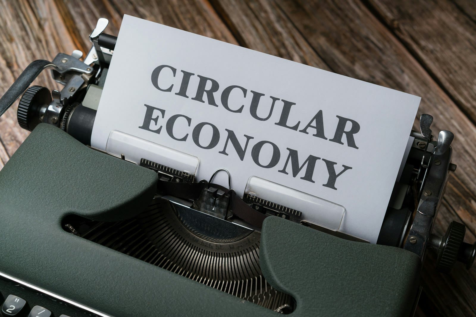 a close up of a typewriter with a paper that reads circular economy