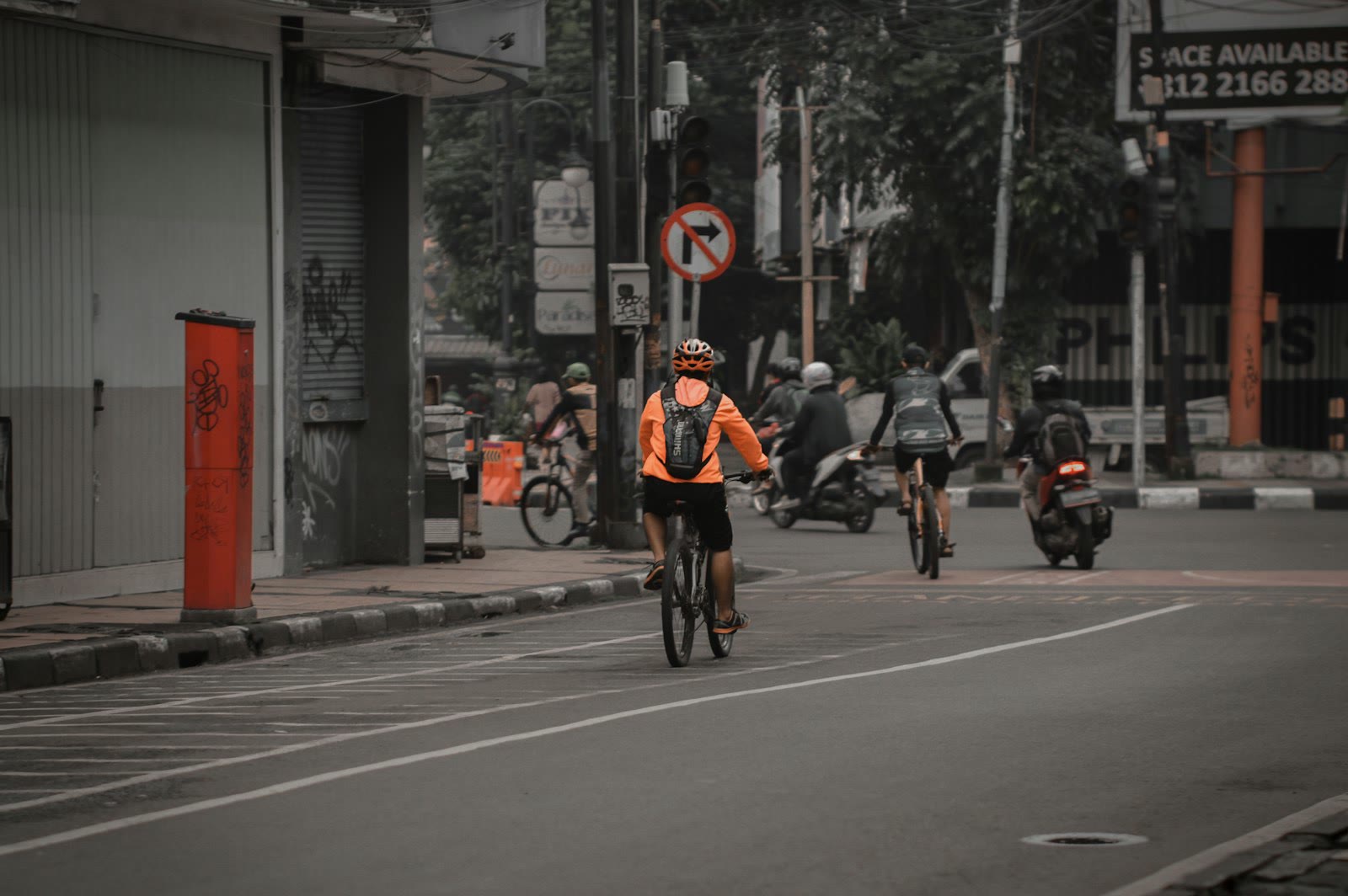 a person riding a bicycle down the street