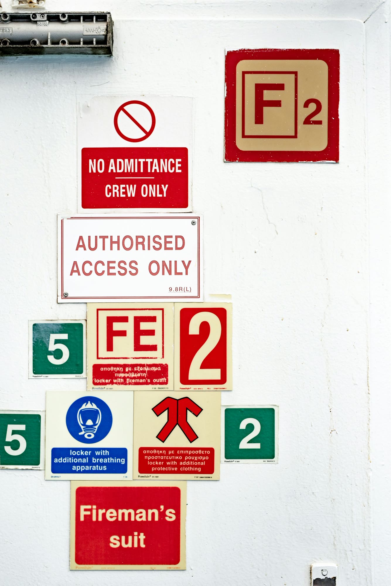 a number of signs on a white wall